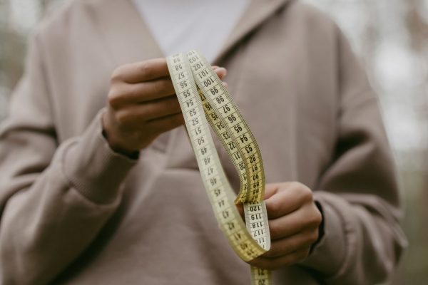 Measuring tape and size chart for finding the perfect fit in baggy emo pants