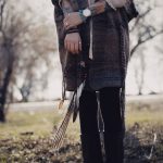 Person styling skinny and Tripp emo pants for fall season with layered alternative fashion outfit