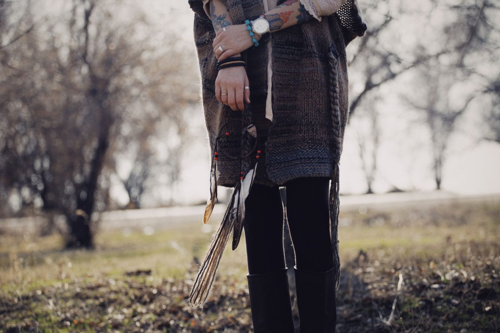 Person styling skinny and Tripp emo pants for fall season with layered alternative fashion outfit